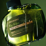 Antipodes Fig and Feijoa Repair and Nourish Shampoo bottle with product pour