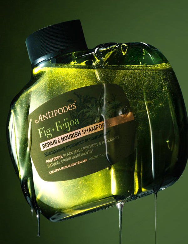 Antipodes Fig and Feijoa Repair and Nourish Shampoo bottle with product pour