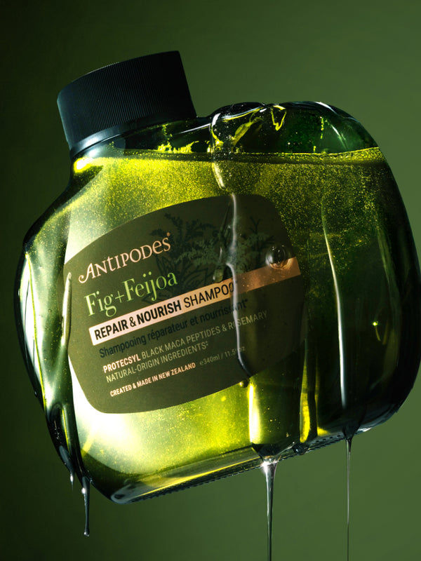 Antipodes Fig and Feijoa Repair and Nourish Shampoo bottle with product pour
