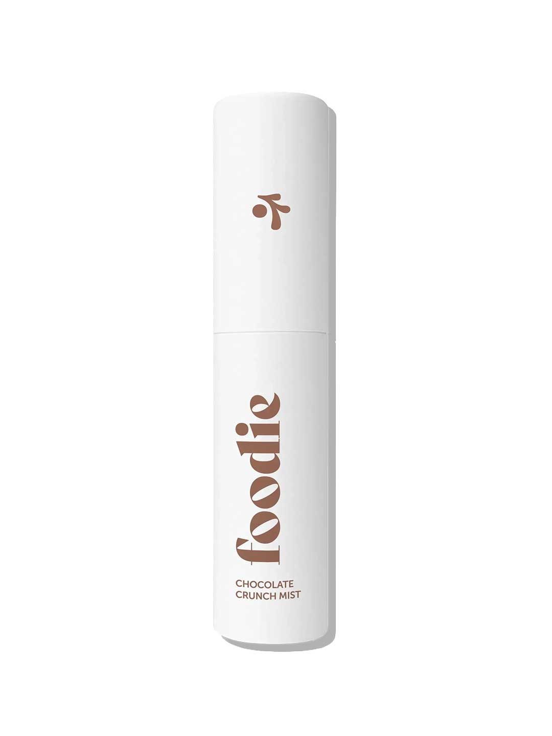 A white cylindrical bottle labeled "Foodie" holds the Chocolate Crunch Face & Body Mist (10ml), shown upright against a white background—ideal as a chocolate-scented mist for teen skincare fans.