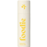 The Foodie Pineapple Crush Kiss Lip Balm 10g comes in a cream-colored cylinder with bold yellow "foodie" text and a fun logo on the cap, offering a playful pineapple-flavored lip balm perfect for teens.