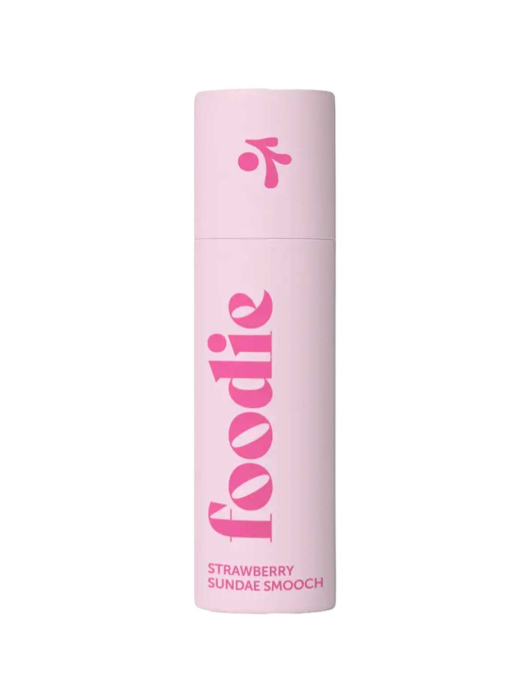 Foodie Strawberry Sundae Smooch Lip Balm 10g comes in a light pink, plastic-free cylindrical tube with “foodie” in bold pink letters and “STRAWBERRY SUNDAE SMOOCH” below. The cap features a small pink design.