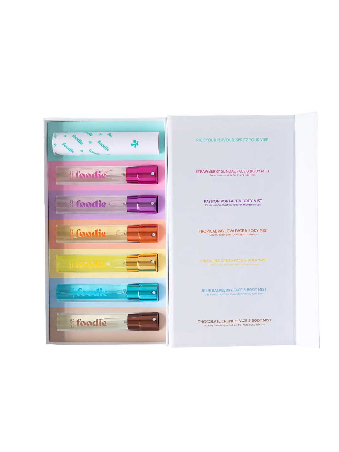 An open box holds the Foodie Sweet Spritz Mist Kit (6 x 10ml), featuring six colorful Face & Body Mists with assorted caps, plus a printed guide showing their fruity scents and names.