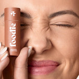 Model wearing Foodie Chocolate Crunch Kiss Lip Balm