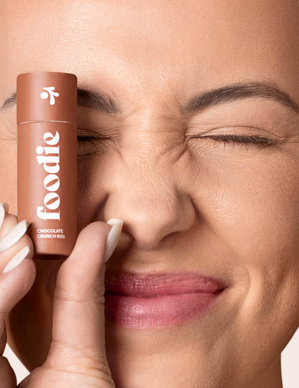 Model wearing Foodie Chocolate Crunch Kiss Lip Balm
