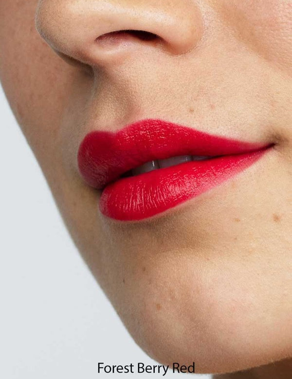 Close-up of a face with smooth skin and full lips wearing Antipodes Moisture Boost Natural Lipsticks 4g in vibrant Forest Berry Red, offers lasting colour and nourishment.