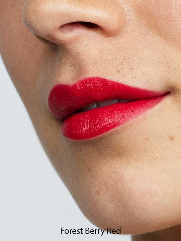 Close-up of a face with smooth skin and full lips wearing Antipodes Moisture Boost Natural Lipsticks 4g in vibrant Forest Berry Red, offers lasting colour and nourishment.