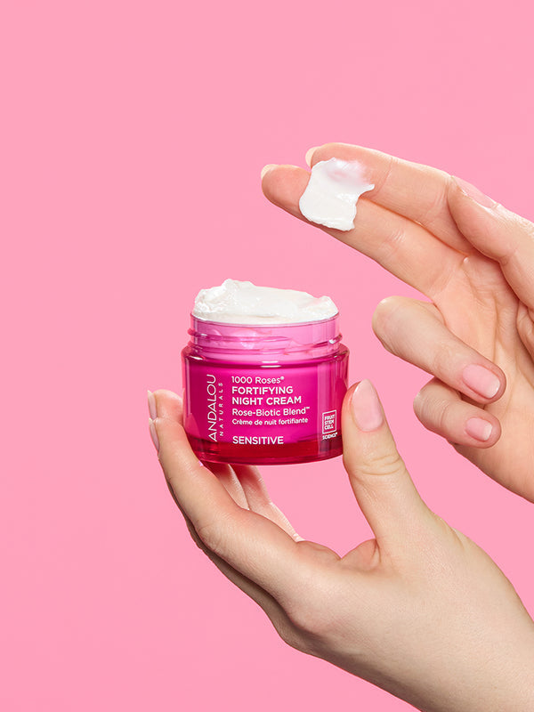 Andalou 1000 Roses Fortifying Night Cream jar held in hand