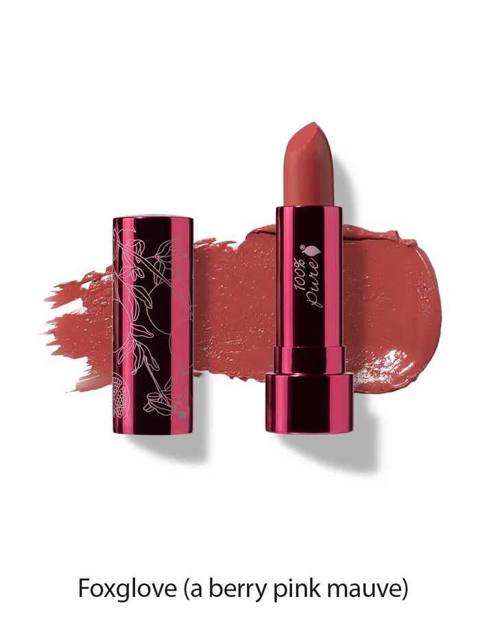 A tube of 100% Pure Pomegranate Oil Moisturising Lipstick 4.5g in berry pink mauve, with its cap beside it. A Foxglove shade swatch is smeared behind, highlighting this moisturising lipstick enriched with pomegranate oil.