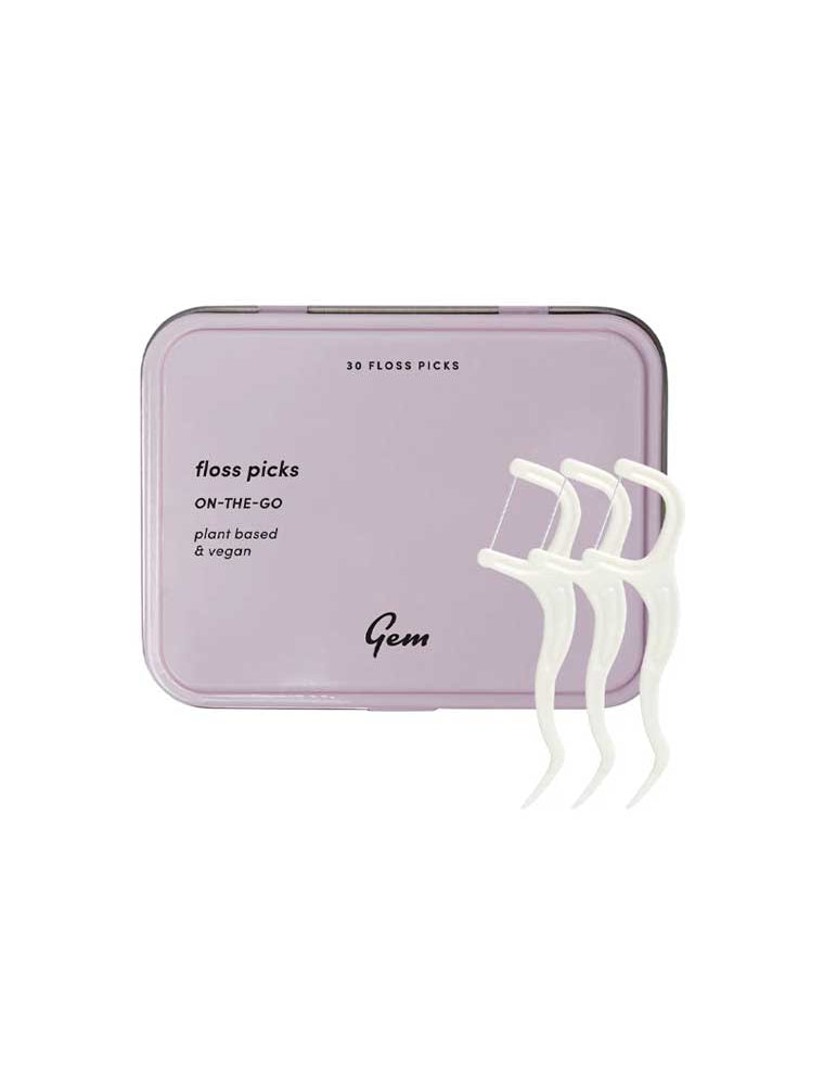 Purple floss pick container with white floss picks on a white background