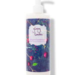 100% Pure Glossy Locks Repair Conditioner in a white pump bottle with a dark blue label covered in colourful fruit and plant illustrations.