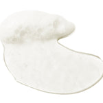 A glossy, translucent swatch of 100% Pure Glossy Locks Glossing Shampoo, forming an uneven puddle with white foam and small bubbles along one edge.