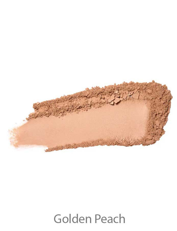 A swatch of 100% Pure Rice Powder Foundation 9g in a warm golden peach shade is spread in a thick streak on a white background, with the text "Golden Peach" written below.