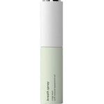 A tall, slim cylindrical bottle of breath spray with a white upper section and a pale mint green lower section, featuring black text that reads 'breath spray' and 'with natural spearmint oil'.