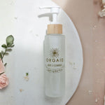 Orgaid Gentle Cleanser styled with flowers on a bathroom vanity