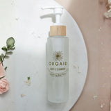 Orgaid Gentle Cleanser styled with flowers on a bathroom vanity