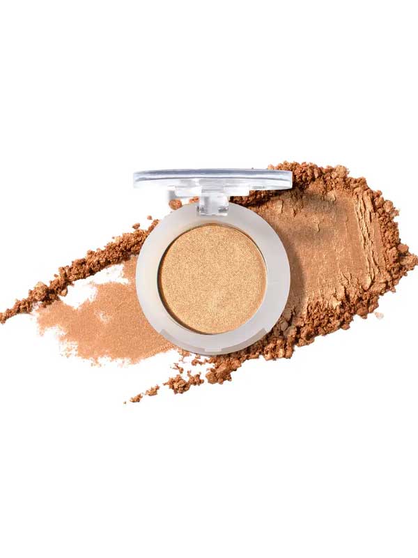 A single open compact of 100% Pure Fruit Pigmented® Eye Shadow 2g by 100% Pure in shimmery gold, with loose powder smeared around it on a white background.