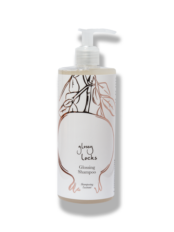 100% Pure Glossy Locks Glossing Shampoo in a clear bottle of pale liquid, with a white pump and a light label showing line drawings of pomegranates and leaves.