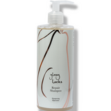 100% Pure Glossy Locks Repair Shampoo in a clear pump bottle containing pale golden liquid, with a mint-green label, curved line drawings and a white pump.