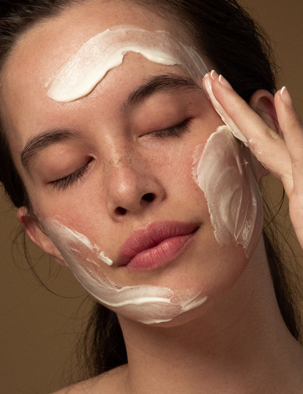 Model massaging Antipodes Grace Gentle Cream Cleanser into her face
