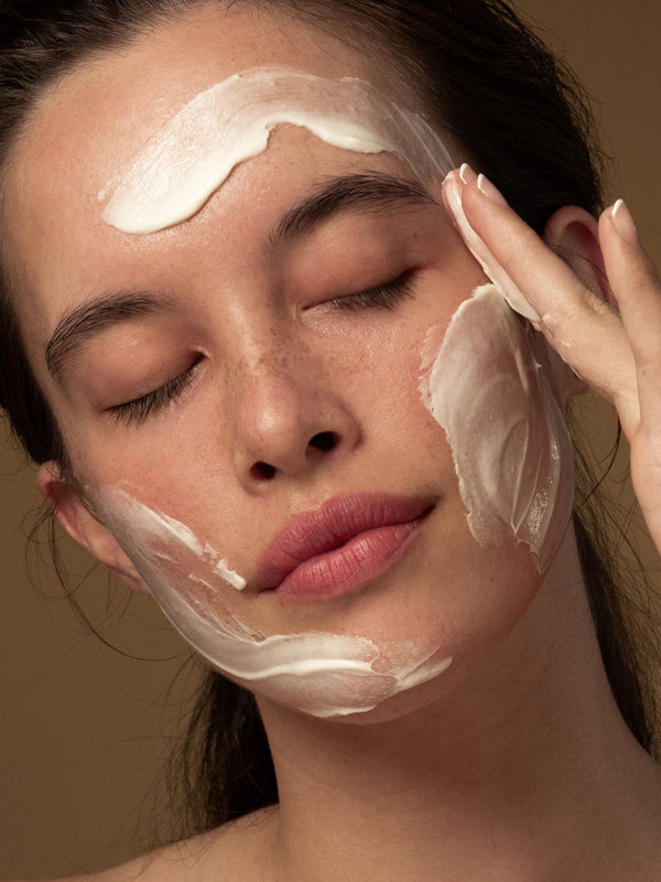 Model massaging Antipodes Grace Gentle Cream Cleanser into her face