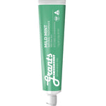 Green tube of Grants Mild Mint toothpaste on a white background