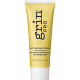 Yellow tube of grin Pro enzyme whitening toothpaste on a white background
