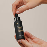 Vanessa Megan Argan and Coconut Hydrating Hair Oil bottle in hand