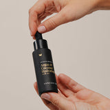 Vanessa Megan Argan and Coconut Hydrating Hair Oil bottle in hand