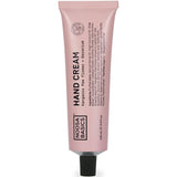 A 100ml pink tube of Noosa Basics Hand Cream Kangaroo Paw Flower + Geranium, with black text and cap, stands upright on a white background.