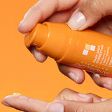 Hand dispensing Andalou Brightening Dark Spot Corrector with 5% Vitamin C