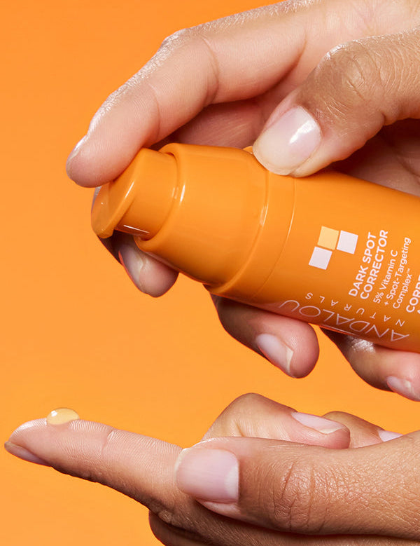 Hand dispensing Andalou Brightening Dark Spot Corrector with 5% Vitamin C