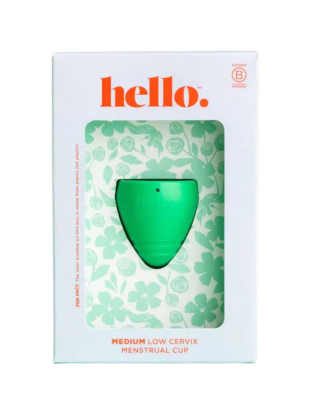 A green Hello Low Cervix Period Cup is shown in white packaging with floral patterns and orange "hello" text. The box highlights it as a Medium Low Cervix Menstrual Cup and notes its hypoallergenic material.