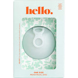 A light green box labeled “Hello Menstrual Disc - Sea Fog” features “hello.” in orange, a floral pattern, and a clear window showing a circular, medical-grade silicone menstrual disc with an inner loop. Box reads One Size Menstrual Disc.