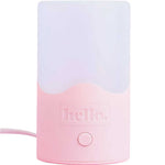 The Hello Steamy Steam Steriliser is a pink and white rectangular night light with a rounded base, single round front button, "hello." printed above it, and side power cord. It doubles as a portable steriliser for added convenience.