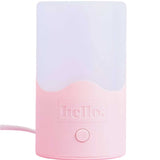The Hello Steamy Steam Steriliser is a pink and white rectangular night light with a rounded base, single round front button, "hello." printed above it, and side power cord. It doubles as a portable steriliser for added convenience.