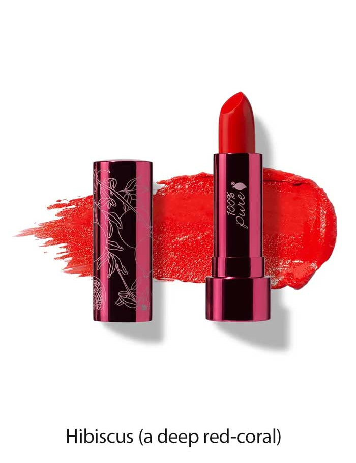 A tube of 100% Pure Pomegranate Oil Moisturising Lipstick 4.5g (vegan, deep red-coral) sits uncapped on a matching swatch. The label reads Hibiscus—a hydrating formula for bold, vibrant lips.