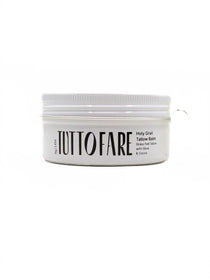 A white 70g jar of Tuttofare Holy Grail Tallow Balm with a white lid features bold black text on the label and finer product details below. This unscented moisturizer is made from grass-fed beef tallow and sits against a plain white background.