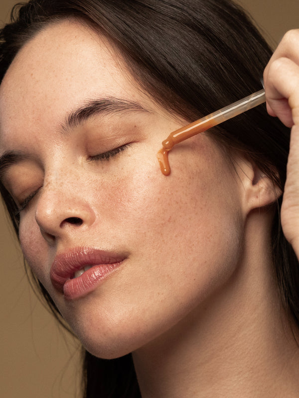 Model applying Antipodes Hosanna Collagen-Plumping Water Serum