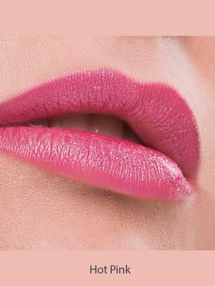 Close-up of lips wearing Benecos Natural Lipsticks 4.5g in a highly pigmented, glossy hot pink shade, against smooth skin and a soft pink background. "Hot Pink" appears below the lips.