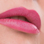 Close-up of lips wearing Benecos Natural Lipsticks 4.5g in a highly pigmented, glossy hot pink shade, against smooth skin and a soft pink background. "Hot Pink" appears below the lips.