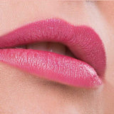 Close-up of lips wearing Benecos Natural Lipsticks 4.5g in a highly pigmented, glossy hot pink shade, against smooth skin and a soft pink background. "Hot Pink" appears below the lips.