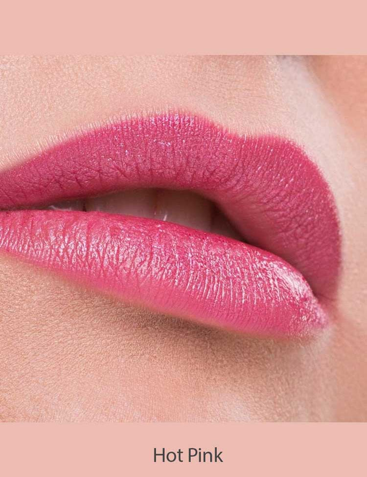 Close-up of lips wearing Benecos Natural Lipsticks 4.5g in a highly pigmented, glossy hot pink shade, against smooth skin and a soft pink background. "Hot Pink" appears below the lips.
