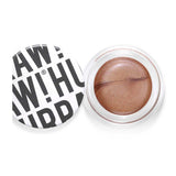 An open Hurraw! Bronze Aura Balm 5.8g reveals its swirled bronze shimmer balm. The white lid sits beside it, bold black "RAW! HURRAH!" text showing. This vegan, multi-use makeup doubles as a radiant glow highlighter.