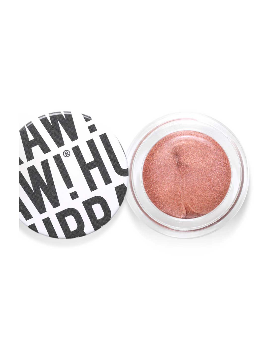 Hurraw! Copper Aura Balm 5.8g is a vegan, shimmery rose-gold cream highlighter in a round container. The white lid, featuring bold black text in a playful, overlapping style, is off and placed to the left of the open balm.