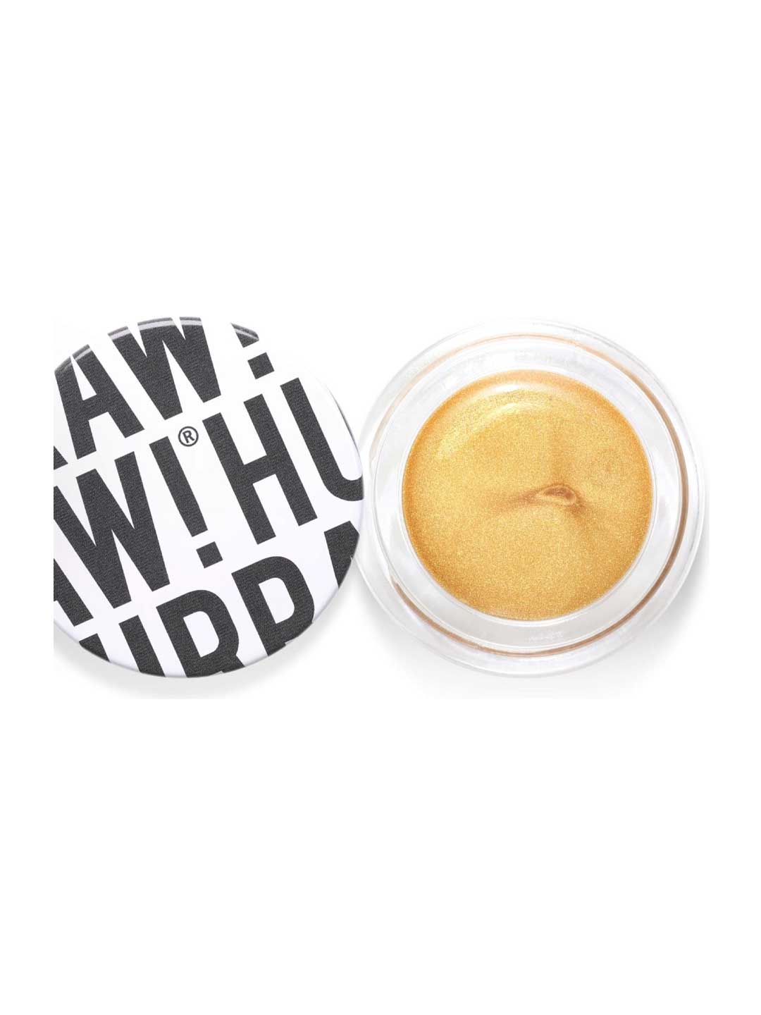An open round container of Hurraw! Gold Aura Balm 5.8g, a vegan gold cream highlighter with a shimmery finish. The white lid, displaying bold black text "RAW! HU", sits slightly askew beside the product.