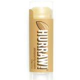 A 4.8g Hurraw! Organic Lip Balm - Almond, with a light brown label showing an almond and white text, stands upright on a white background.