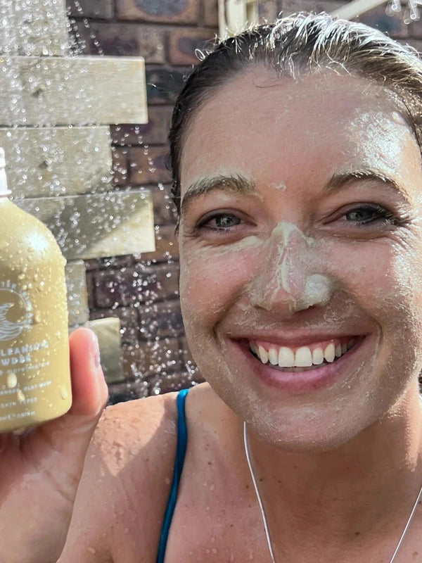 SunButter Deep Cleansing Powder held beside face