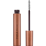 A metallic bronze tube of INIKA Organic Bold Lash Mascara Black 13ml with the cap off and the white bristle wand standing upright beside it, highlighting this volumising mascara’s elegant packaging.