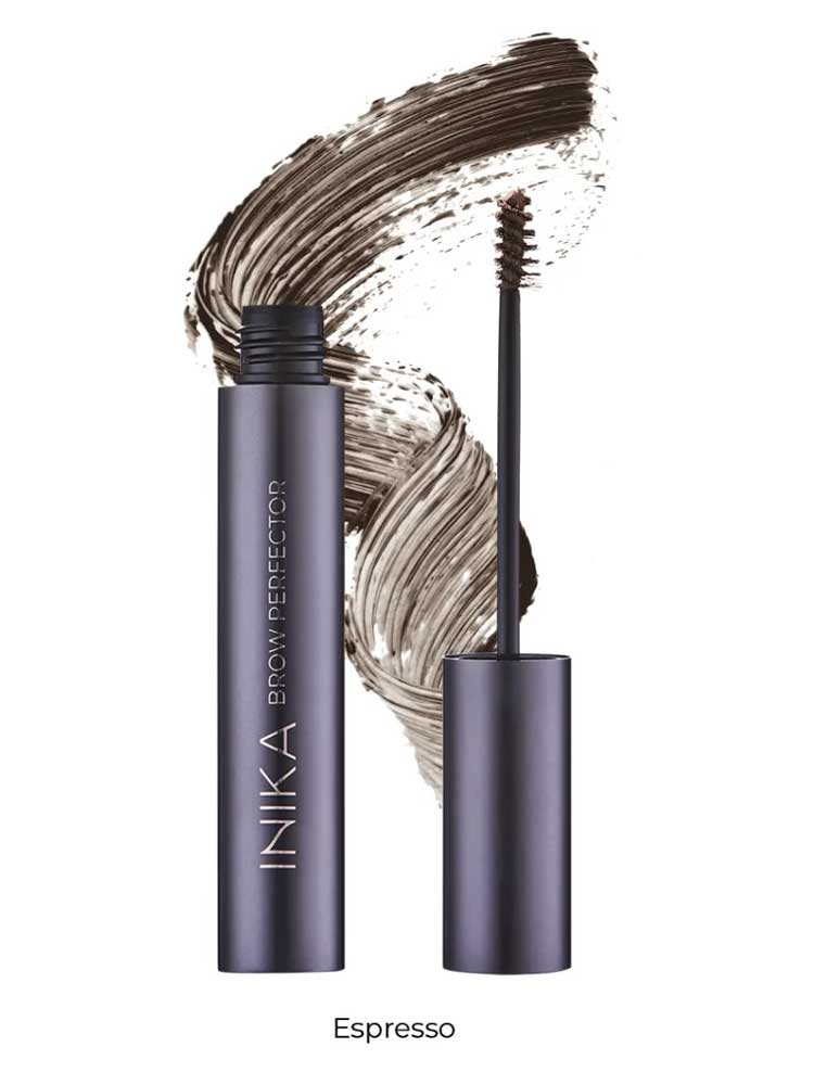 A tube of INIKA Organic Brow Perfector 6.5ml in Espresso, uncapped to show the brush applicator, displayed in front of a brown natural eyebrow gel swatch.